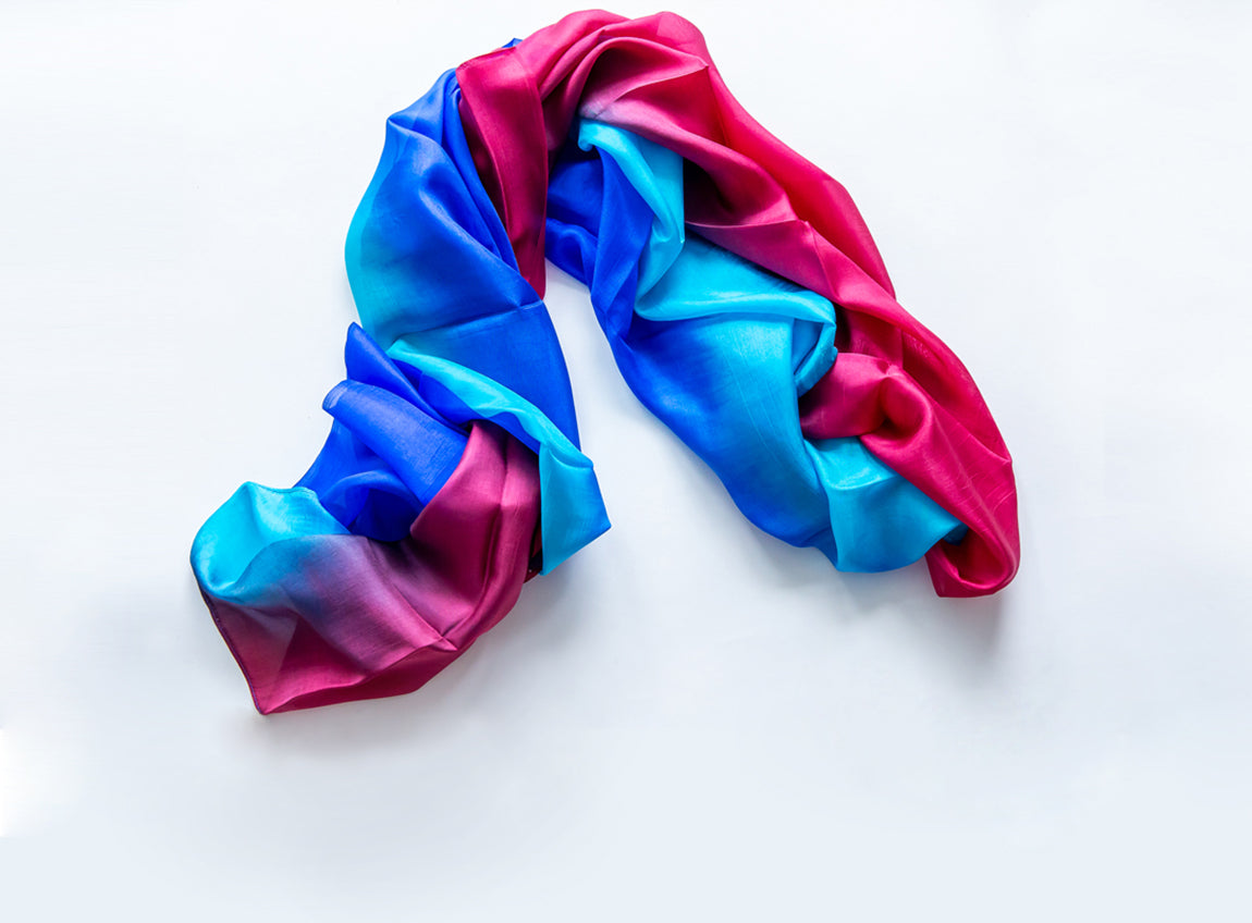A crumpled silk scarf in vivid blue, pink, and purple colors.