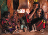 A woman and her four children sit on the ground under a tent filled with textiles.