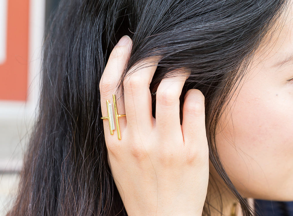 A close-up of the adjustable brass ring on a girl’s index finger.